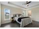 Well lit main bedroom features a large bed, trey ceiling, and view to the en-suite bathroom at 803 Marquis Ct, Kissimmee, FL 34759