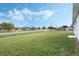 Expansive grassy lot featuring a corner property with community green spaces, a playground, and open skies at 803 Marquis Ct, Kissimmee, FL 34759