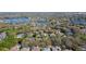 An aerial view shows lakeside homes in a lush, green community with pools and beautiful trees at 806 Roswell Cv, Lake Mary, FL 32746