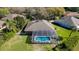 Aerial view of the property featuring a screened-in pool, lush landscaping, and a well-maintained home exterior at 806 Roswell Cv, Lake Mary, FL 32746