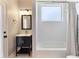 Bathroom featuring a black vanity, white subway tile, a shower, and a neutral color scheme at 806 Roswell Cv, Lake Mary, FL 32746