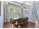 Dining room with hardwood floors, decorative curtains, and a modern hanging light fixture at 806 Roswell Cv, Lake Mary, FL 32746