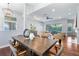 Open-concept dining room featuring hardwood floors, modern light fixture, and views of the living space at 806 Roswell Cv, Lake Mary, FL 32746