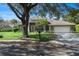 Single story home with manicured lawn, mature trees, two car garage, and charming mailbox at 806 Roswell Cv, Lake Mary, FL 32746