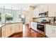 Spacious kitchen with white cabinetry, granite countertops, stainless steel appliances, and hardwood floors at 806 Roswell Cv, Lake Mary, FL 32746