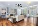 Bright and airy living room with hardwood floors, a fireplace, and an open layout to the dining area at 806 Roswell Cv, Lake Mary, FL 32746