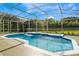 Sparkling screened-in pool with crystal-clear water and lush landscaping, ideal for summer fun and relaxation at 806 Roswell Cv, Lake Mary, FL 32746