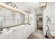 Bright bathroom features double sinks, a large mirror, and stylish lighting fixtures at 936 Allendale Ln, Winter Garden, FL 34787