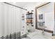 Modern bathroom with a tub and shower, floating shelves and modern fixtures at 936 Allendale Ln, Winter Garden, FL 34787