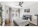 Cozy bedroom with a queen-sized bed, patterned curtains, and two windows at 936 Allendale Ln, Winter Garden, FL 34787