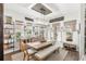 Inviting dining room with wood table, chandelier, and shelves, complemented by natural light from the windows at 936 Allendale Ln, Winter Garden, FL 34787