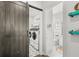 Laundry room has a sliding barn door and modern washer and dryer at 936 Allendale Ln, Winter Garden, FL 34787