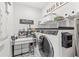 Well organized laundry room with built-in shelving and updated appliances at 936 Allendale Ln, Winter Garden, FL 34787