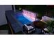 A modern pool design with patio furniture and a lit water feature at 936 Allendale Ln, Winter Garden, FL 34787