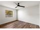 This bedroom boasts wood-look flooring and natural light from the window, with simple decor at 9360 Sonia St, Orlando, FL 32825