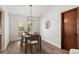 Bright dining room with modern lighting, neutral walls, and a view of the outdoor pool at 9360 Sonia St, Orlando, FL 32825