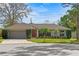 Charming single-story home with a well-maintained lawn and a two-car garage at 9360 Sonia St, Orlando, FL 32825