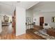 Bright hallway showcasing wood flooring and views into the living spaces at 9360 Sonia St, Orlando, FL 32825