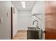 Laundry room features a stainless steel sink, and minimalist shelving for a clean, functional space at 9360 Sonia St, Orlando, FL 32825