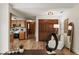 Open living space connecting kitchen and sitting area, showcasing modern decor and wood floors at 9360 Sonia St, Orlando, FL 32825