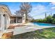 Backyard view showcases a sparkling pool and manicured landscaping creating a private retreat at 9360 Sonia St, Orlando, FL 32825