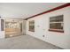 Covered patio with red trim and view into enclosed sunroom through sliding glass doors at 1109 Denton Rd, Winter Park, FL 32792