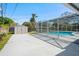 Pool with screen, shed, and driveway at 1109 Denton Rd, Winter Park, FL 32792