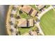 An aerial view of a house with a tile roof, a lush green lawn, and a view of a serene pond at 12016 Lorenza Ln, Orlando, FL 32827