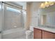 Bathroom with bathtub, shower, granite countertop vanity, and tiled walls at 12016 Lorenza Ln, Orlando, FL 32827