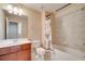 Cozy bathroom featuring a vanity sink, toilet, and bathtub with tiled walls at 12016 Lorenza Ln, Orlando, FL 32827