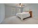 Bright bedroom with a ceiling fan, white bedding, and a door that leads to an outdoor space at 12016 Lorenza Ln, Orlando, FL 32827