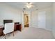 Bedroom featuring a desk, ceiling fan, and view into bathroom at 12016 Lorenza Ln, Orlando, FL 32827