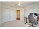 Bedroom featuring carpeted floors, a ceiling fan, and a large closet space for storage at 12016 Lorenza Ln, Orlando, FL 32827