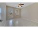 Neutral bedroom featuring tiled floor, ceiling fan, glass door, and bright window at 12016 Lorenza Ln, Orlando, FL 32827