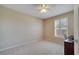 Neutral bedroom with ceiling fan, carpet and window with plantation shutters at 12016 Lorenza Ln, Orlando, FL 32827