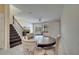 Open dining room with dark wood table, staircase, and comfortable couch in the background at 12016 Lorenza Ln, Orlando, FL 32827