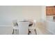 Simple dining room area featuring a round, dark wood table and four fabric chairs at 12016 Lorenza Ln, Orlando, FL 32827