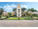 Clock tower and clubhouse exterior with lush tropical landscaping at 12016 Lorenza Ln, Orlando, FL 32827