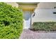 A welcoming front entrance with a white door, brick walkway, and neatly trimmed bushes at 12016 Lorenza Ln, Orlando, FL 32827