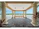 Picturesque lake view from inside the gazebo with elegant columns and a relaxing bench at 12016 Lorenza Ln, Orlando, FL 32827