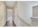 Inviting hallway featuring dark wood floors and neutral-toned walls leading to a bedroom at 12016 Lorenza Ln, Orlando, FL 32827