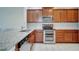 Well-equipped kitchen featuring stainless steel appliances, granite countertops, and tile backsplash at 12016 Lorenza Ln, Orlando, FL 32827