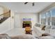 A bright living room with tile flooring, a white sofa, and a view from the large windows at 12016 Lorenza Ln, Orlando, FL 32827