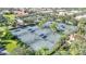 Aerial view of well-maintained tennis courts with blue shaded benches in a beautiful community at 12016 Lorenza Ln, Orlando, FL 32827