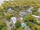 Aerial shot showcases beautiful homes, pools, and lush greenery in a quiet, upscale neighborhood with mature trees at 1213 Richmond Rd, Winter Park, FL 32789