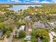 Aerial view of a charming neighborhood with lush greenery, showcasing the community's serene setting and beautiful lake at 1213 Richmond Rd, Winter Park, FL 32789