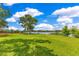 Expansive backyard with lush green lawn, mature trees, and lake views, providing a serene outdoor retreat at 1213 Richmond Rd, Winter Park, FL 32789