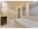 Bathroom with tiled soaking tub, marble countertops, and a vanity with an undermount sink at 1213 Richmond Rd, Winter Park, FL 32789