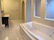 Bathroom with large tub, vanity and tile floors at 1213 Richmond Rd, Winter Park, FL 32789