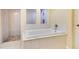 Bathroom with a soaking tub and a separate glass enclosed shower area with patterned tile floor at 1213 Richmond Rd, Winter Park, FL 32789